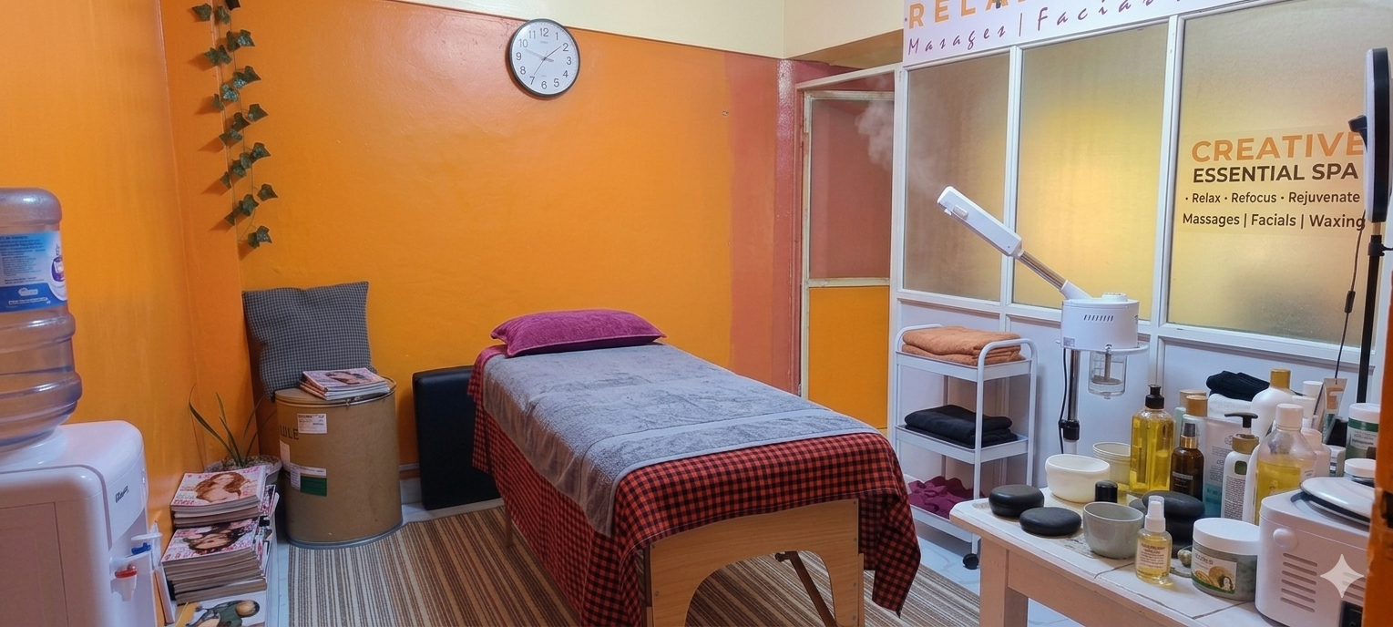 Creative Essential Spa therapist preparing treatment room with warm lighting and oils at dusk, Naivasha